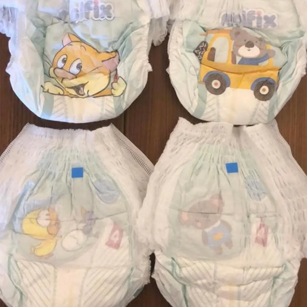 Four baby diapers with colorful cartoon animal illustrations including a cat, bear driving a car, a duck, and a mouse.