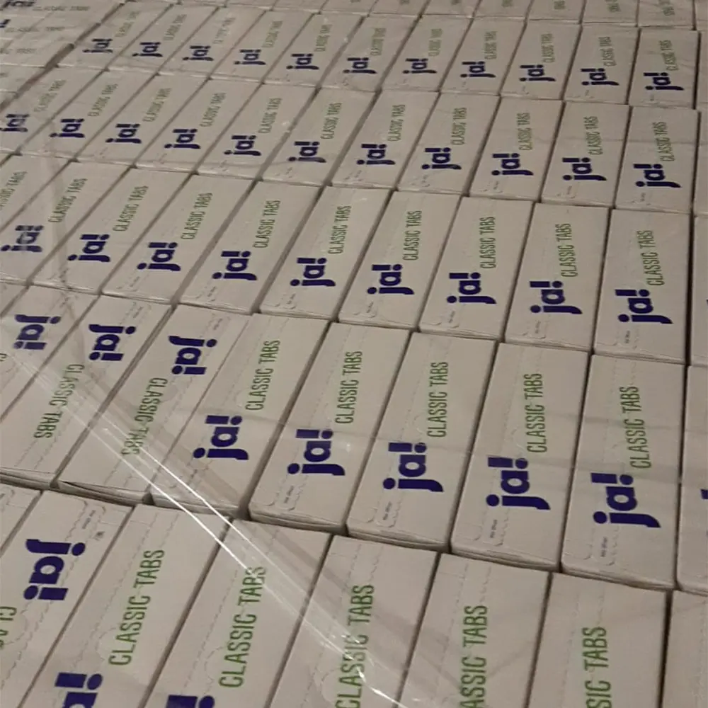 Stacks of white boxes labeled 'ja! CLASSIC TABS' arranged in neat rows, wrapped in clear plastic.